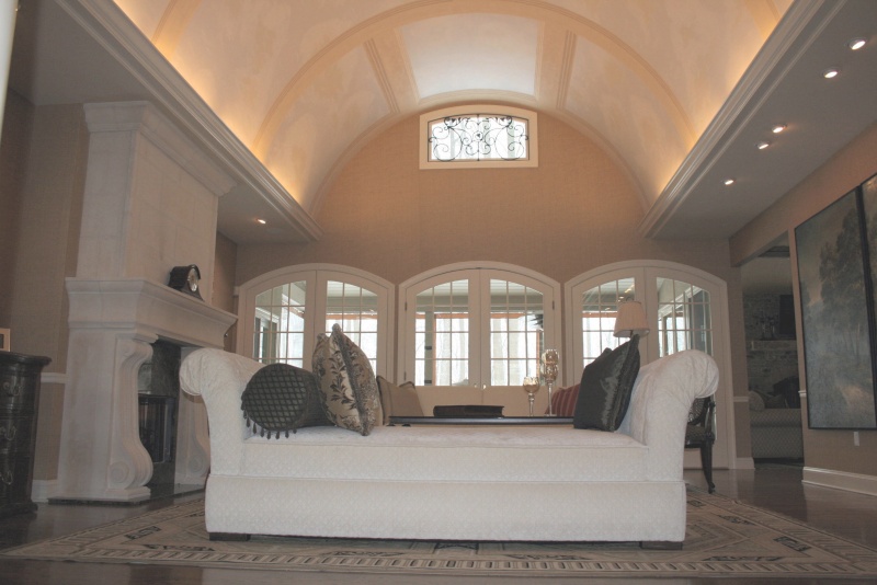 Vaulted living room detailed with stone arches 